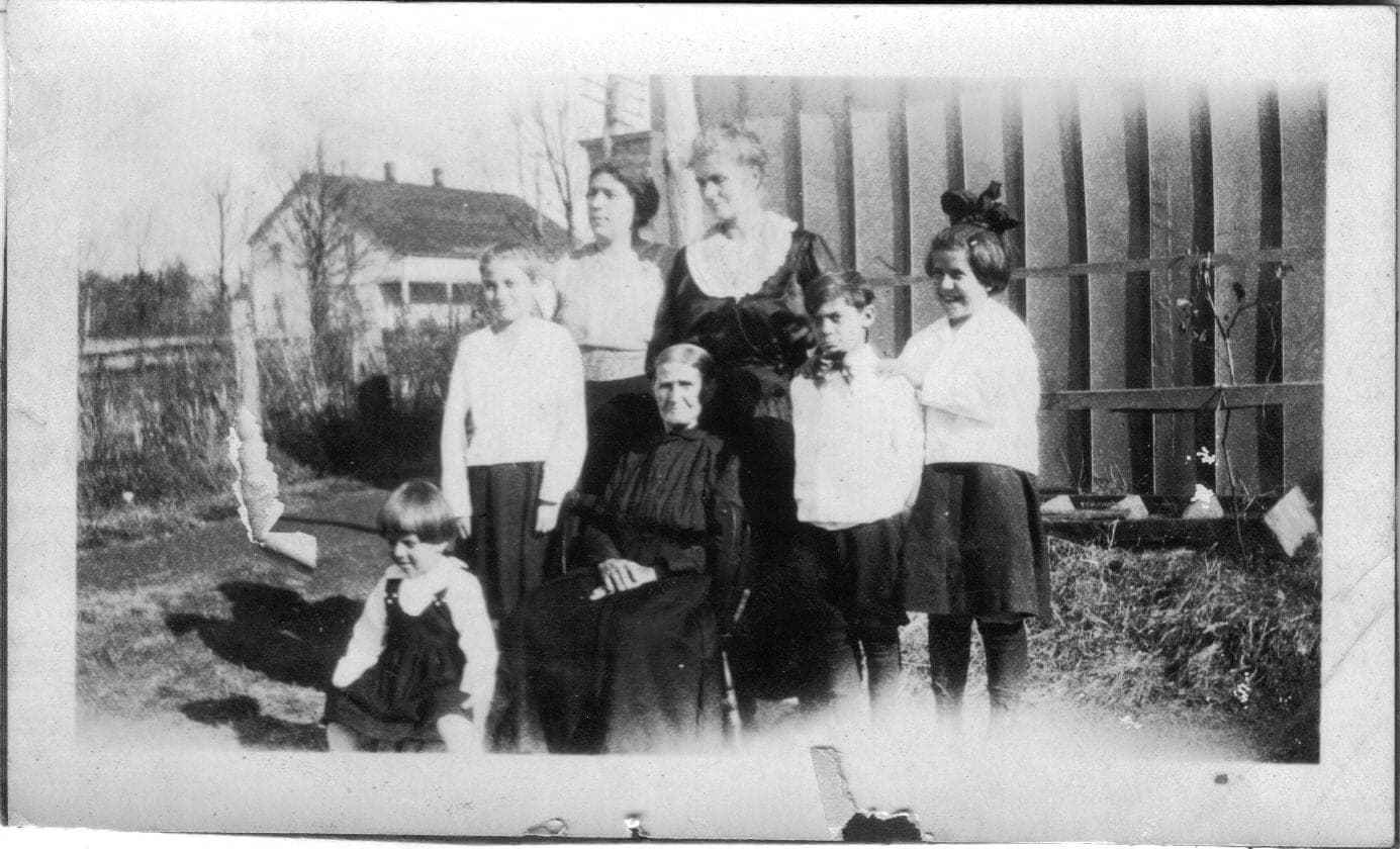 A family gathered outdoors in the early 1900s